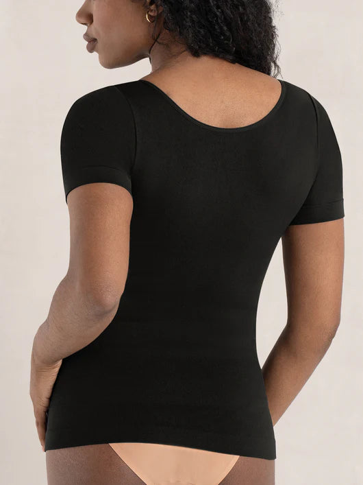 Front view of woman wearing a black short sleeve shaping t-shirt with everyday tummy control and comfort